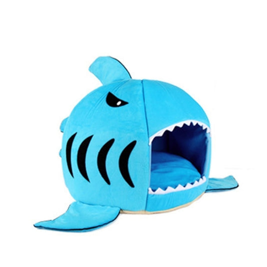 Blue shark-shaped pet sleeping bed with side view and soft interior cushion