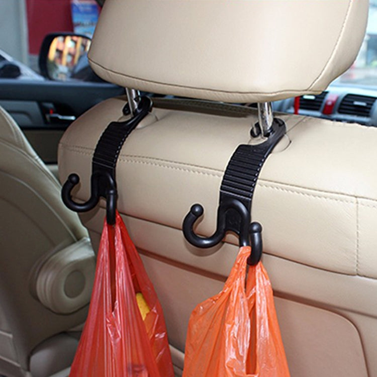 Car seat back hooks clipped to beige seats, holding two orange bags