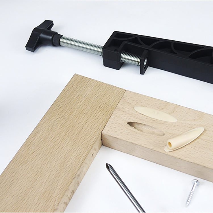 Clamp bar and oblique hole locator jig set on wood with visible pre-drilled opening