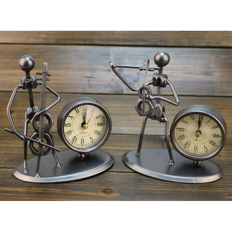 Pair of retro small alarm clocks with metal figure stands and round cream Roman numeral dials