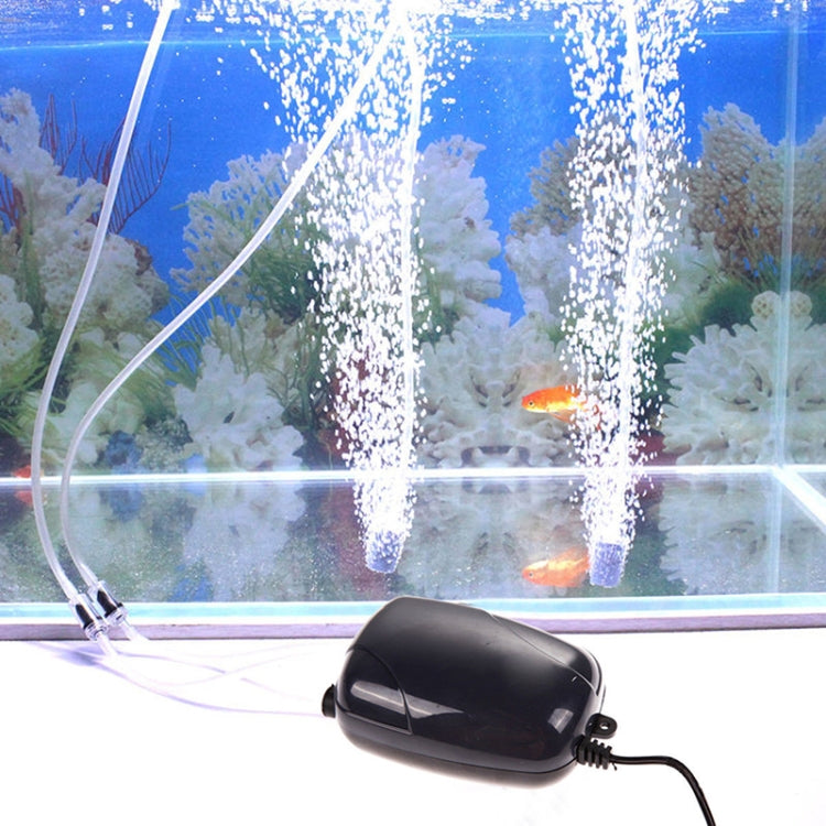 Aquarium air pump releasing bubbles from black housing with connected air line