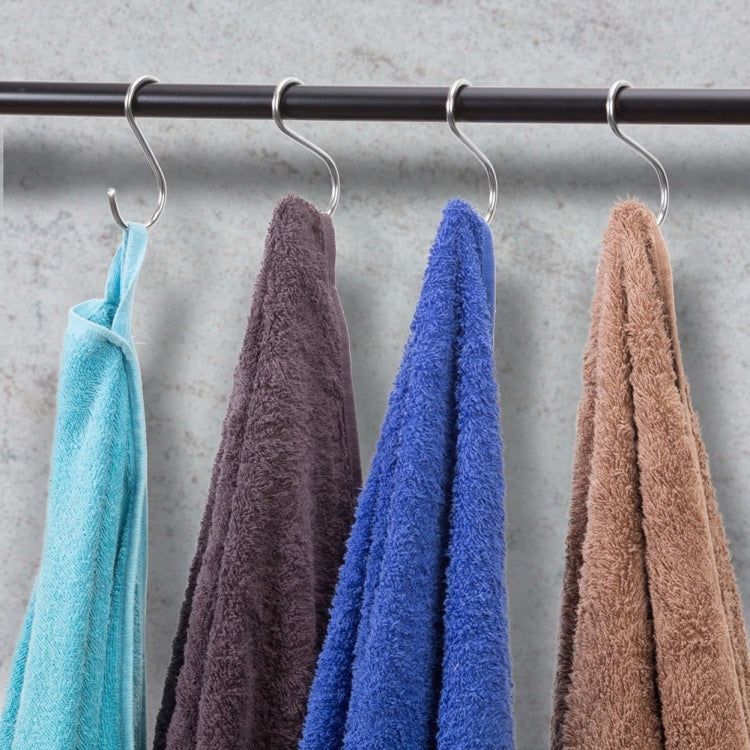 S-shaped stainless steel hooks holding four towels on a wall-mounted rod