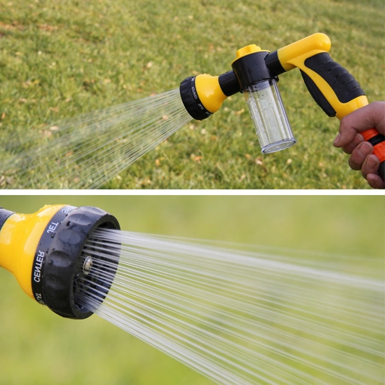 Yellow foam water gun sprayer projecting fine fan mist with clear reservoir