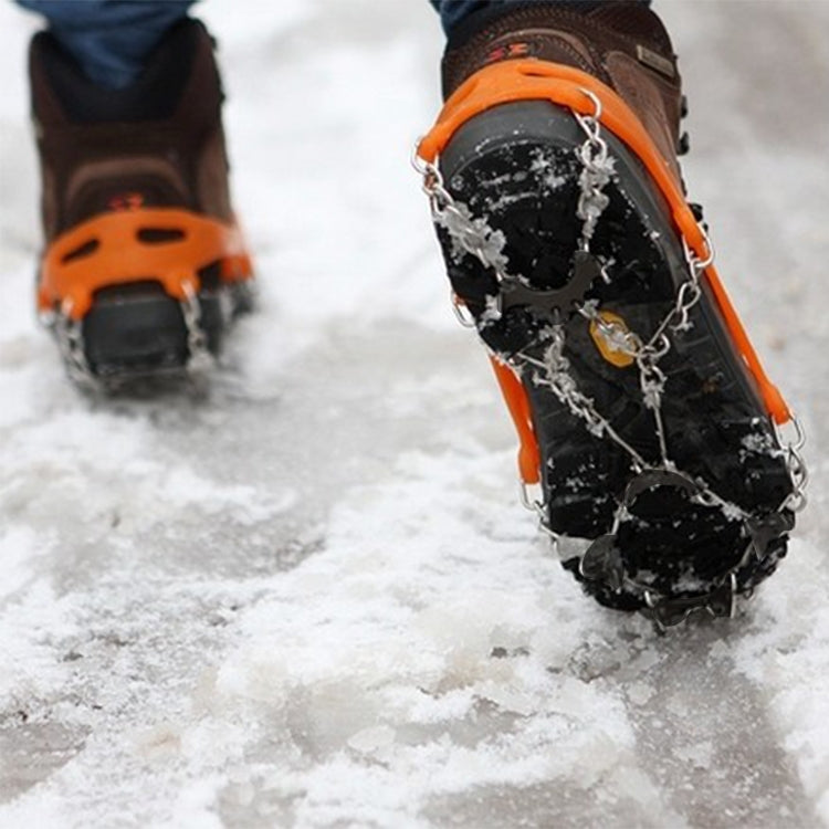 Orange ice gripper shoe cover with metal chains and 8-tooth spikes on boot