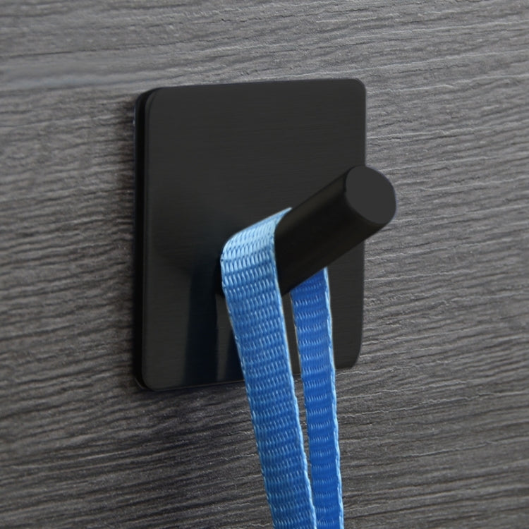 Black oblique coat hook holding a blue strap on a square mounting plate