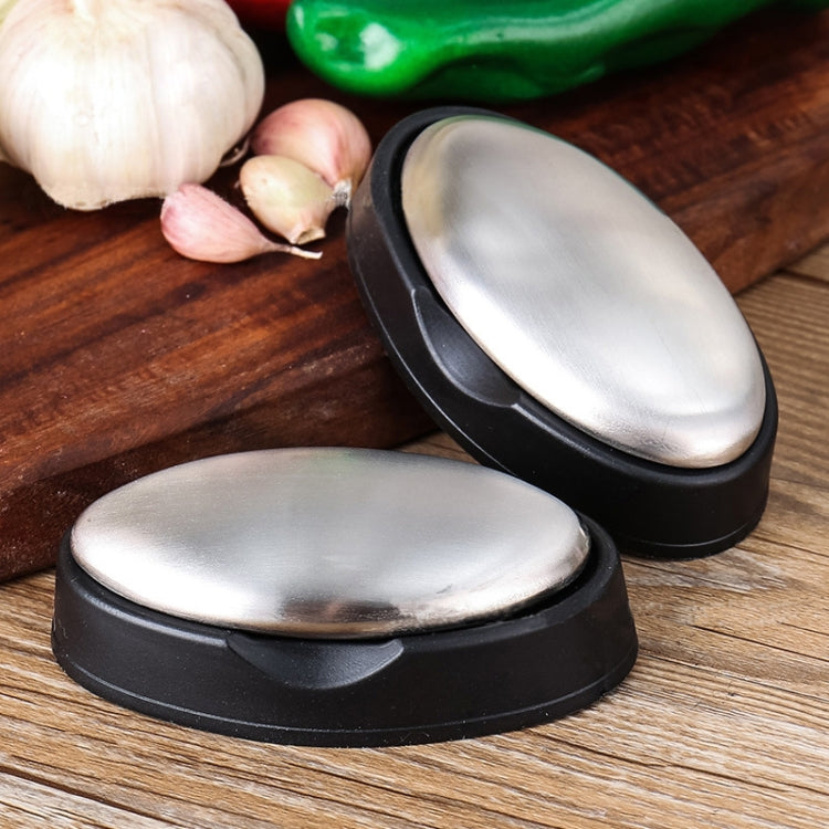 Two stainless steel oval soap bars with black bases, one upright