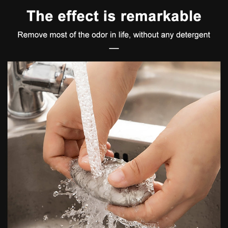 Oval stainless steel soap bar surrounded by running water in hands