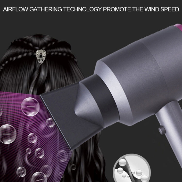 Grey hair dryer blowing air toward hair, purple-ring nozzle focused on airflow speed