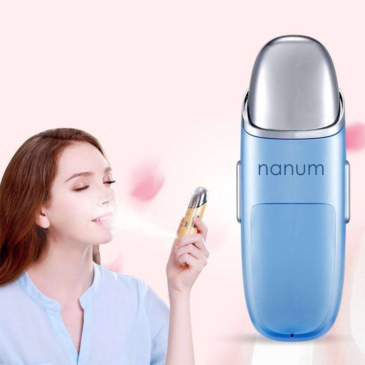 Blue facial hydrating massager with chrome dome top; handheld mist sprayer