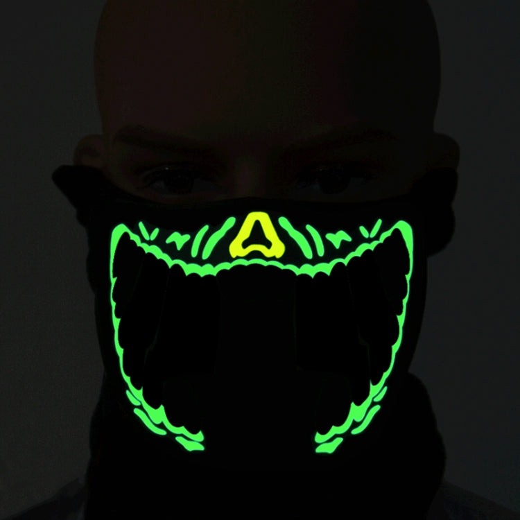 Black fabric LED Halloween face mask with vivid green glowing jagged grin mouth design