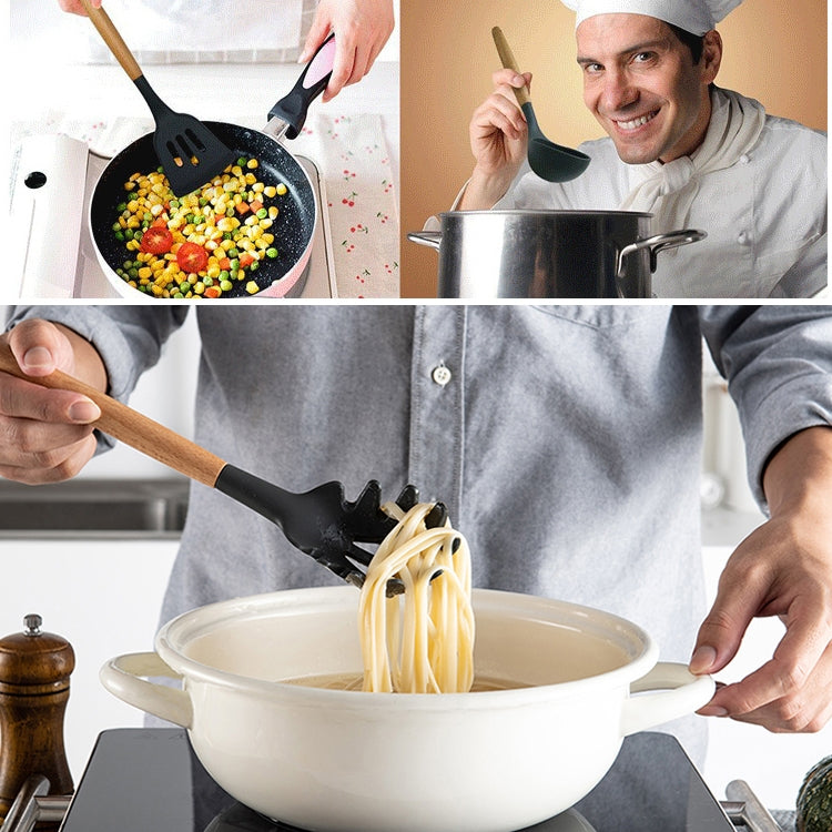 Chef stirring pasta in a pot with black silicone spatula and wooden handle