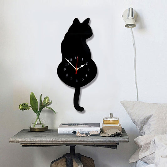 Black cat-shaped wall clock with round face and red clock hands