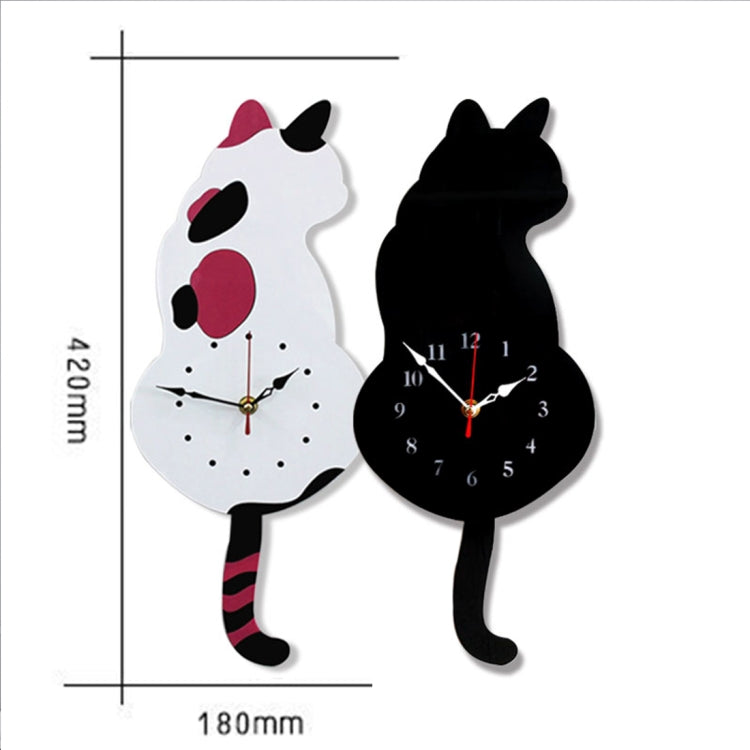 Set of white and black cat-shaped wall clocks with round faces and red hands