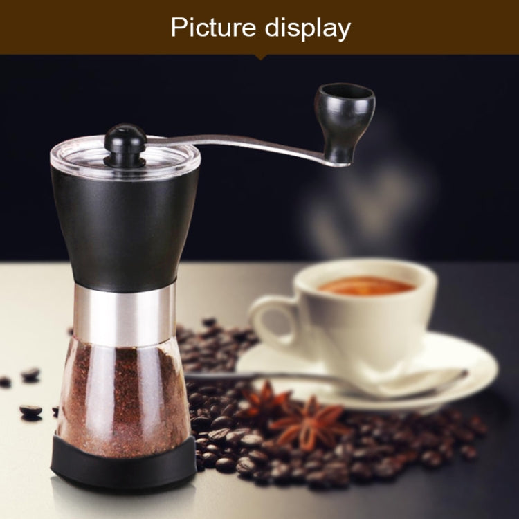 Manual conical burr grinder with black hopper, stainless body, and ground coffee chute