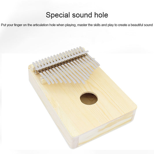 Light wood kalimba with round articulation hole and silver metal tines, angled view.