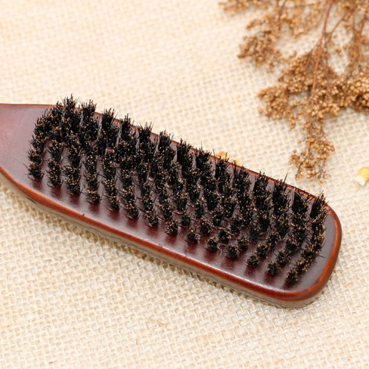 Boar bristle beard brush head on brown-trimmed wooden base