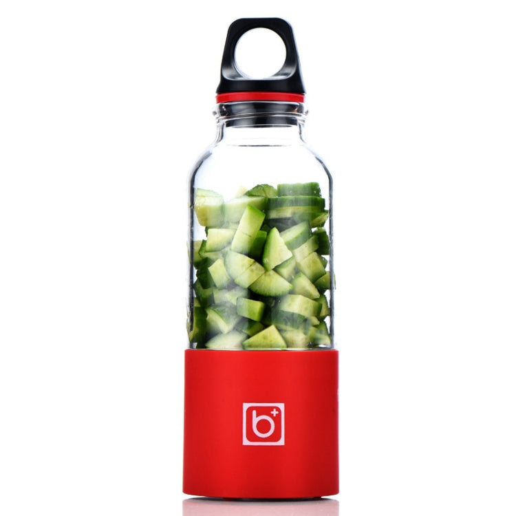 Portable electric juicer cup with red base and diced green vegetables inside
