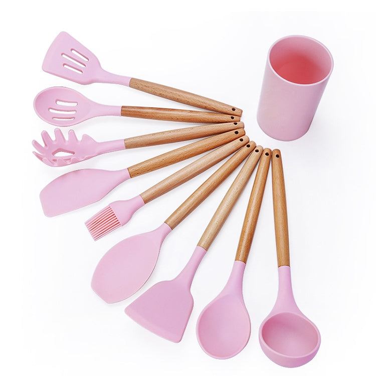 Pink silicone kitchen tool set with wooden handles and storage bucket cup