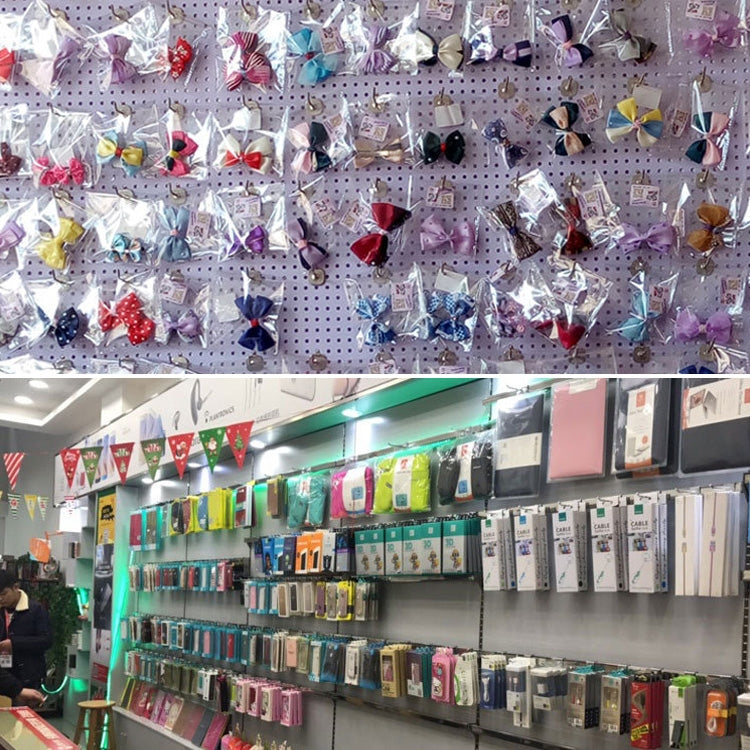 Slat wall display with rows of chrome pegboard hooks holding merchandise