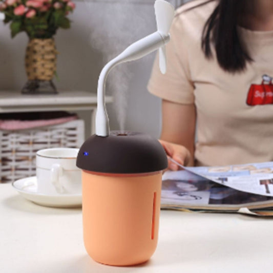 USB aroma humidifier in mushroom shape, dark cap with orange tank on desk