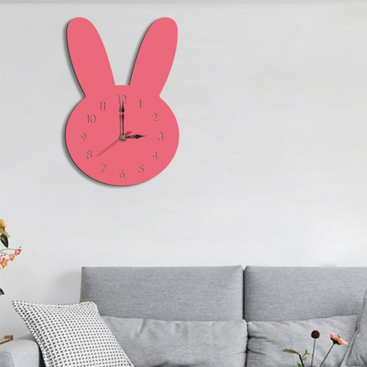 Pink rabbit-shaped wall clock with black hour and minute hands and red numerals