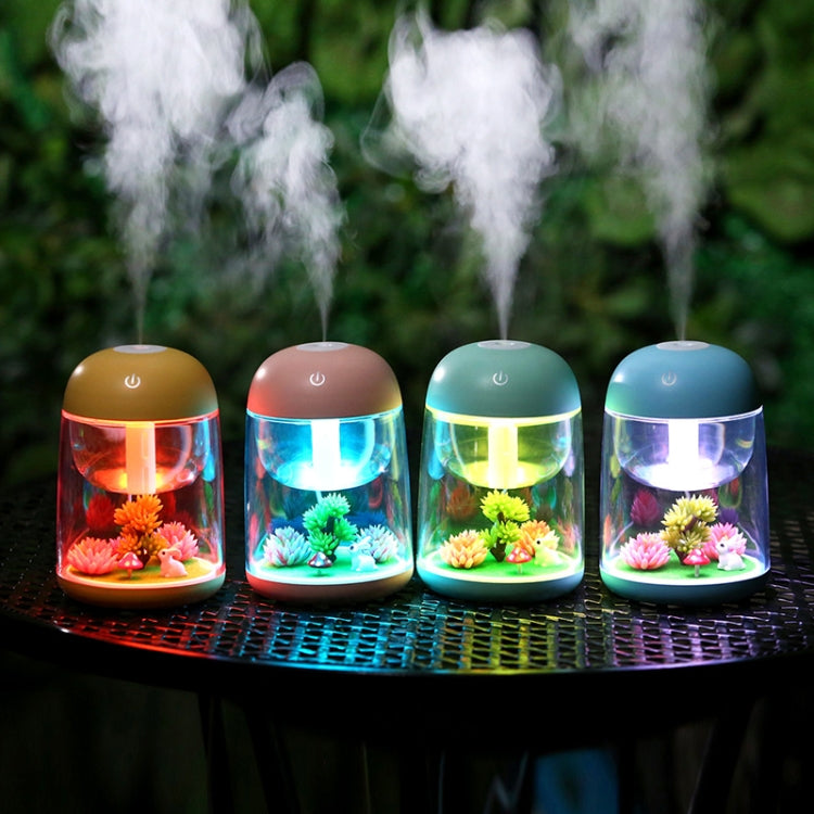 Set of four mini humidifiers with colorful LED lights and mist, each with faux plants