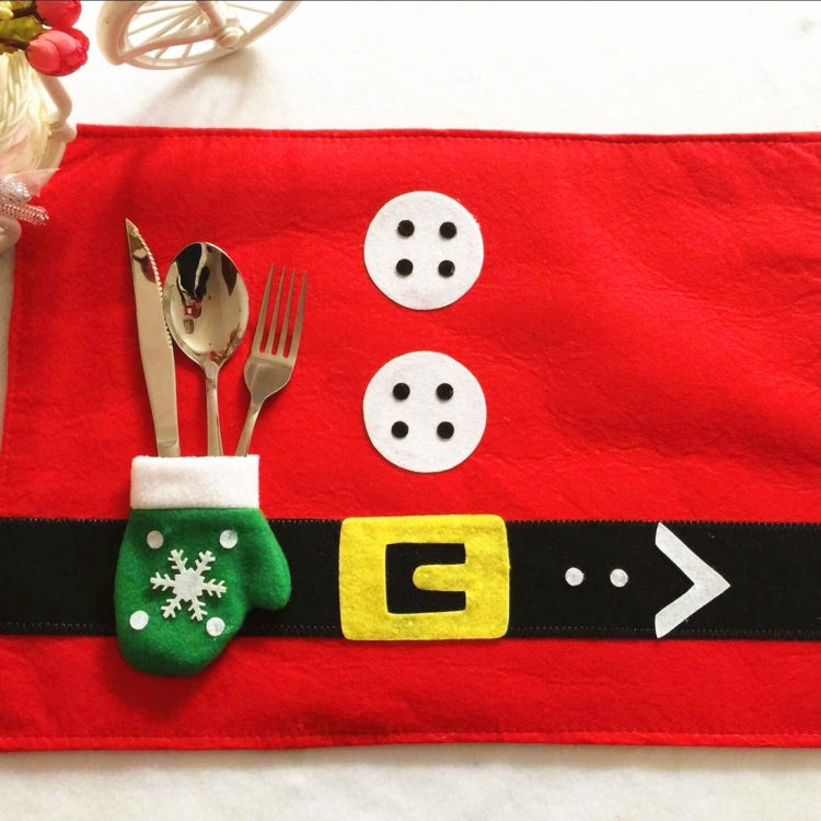 Red Santa placemat with black belt, three white button discs, cutlery in mitten pocket
