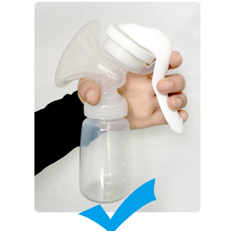 Manual breast milk pump held in hand, with breast shield and transparent bottle