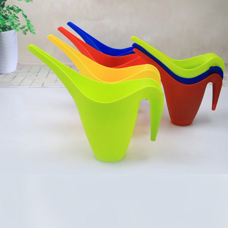 Plastic watering pots with long spouts and handles, assorted bright colors in a row