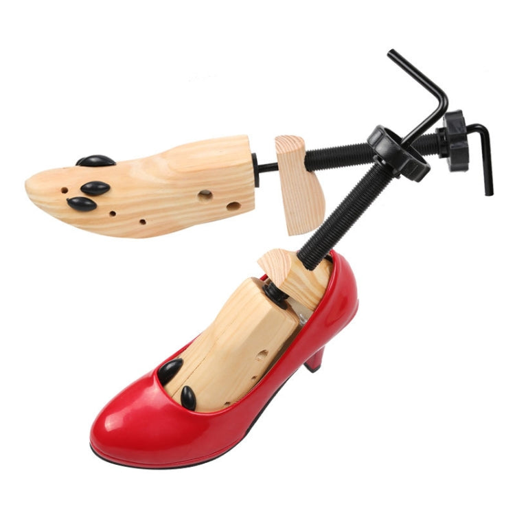 Wooden shoe stretcher expander inserted into a red high-heel shoe, size S