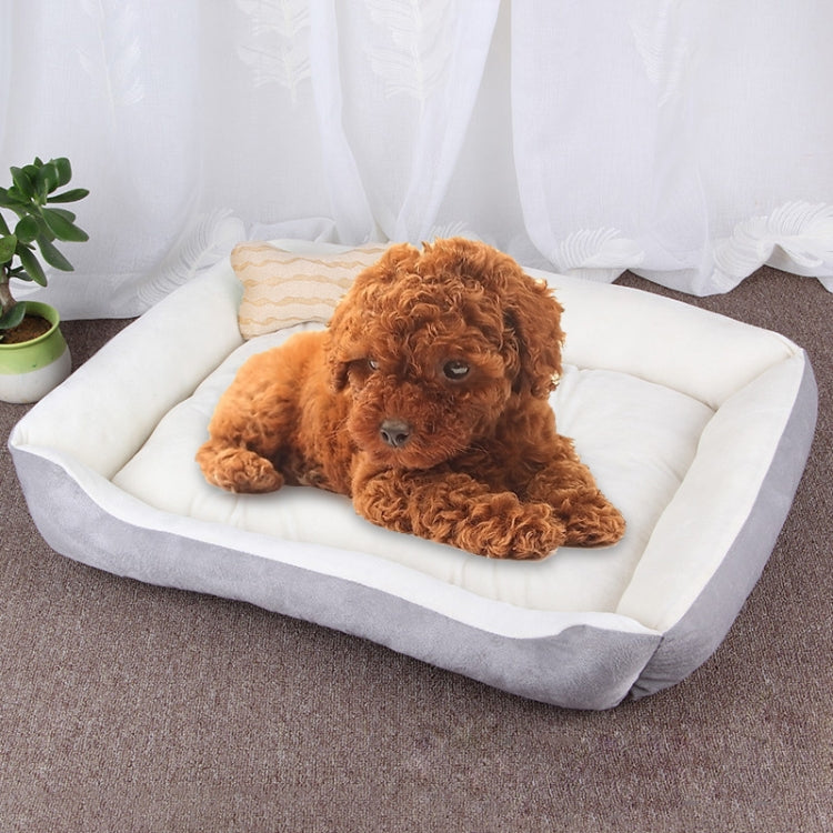 Light-colored pet kennel mat with dark border, white cushion, and tan puppy