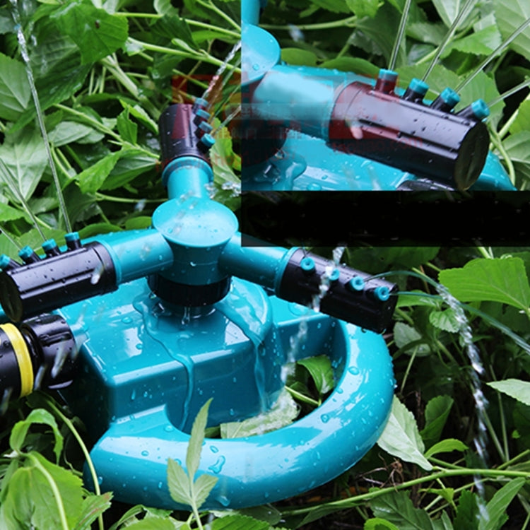 Teal 360° sprinkler head with rotating arms and black spray barrels