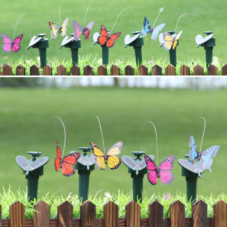 Set of solar rotating butterfly garden toys on stakes, colorful wings in a row
