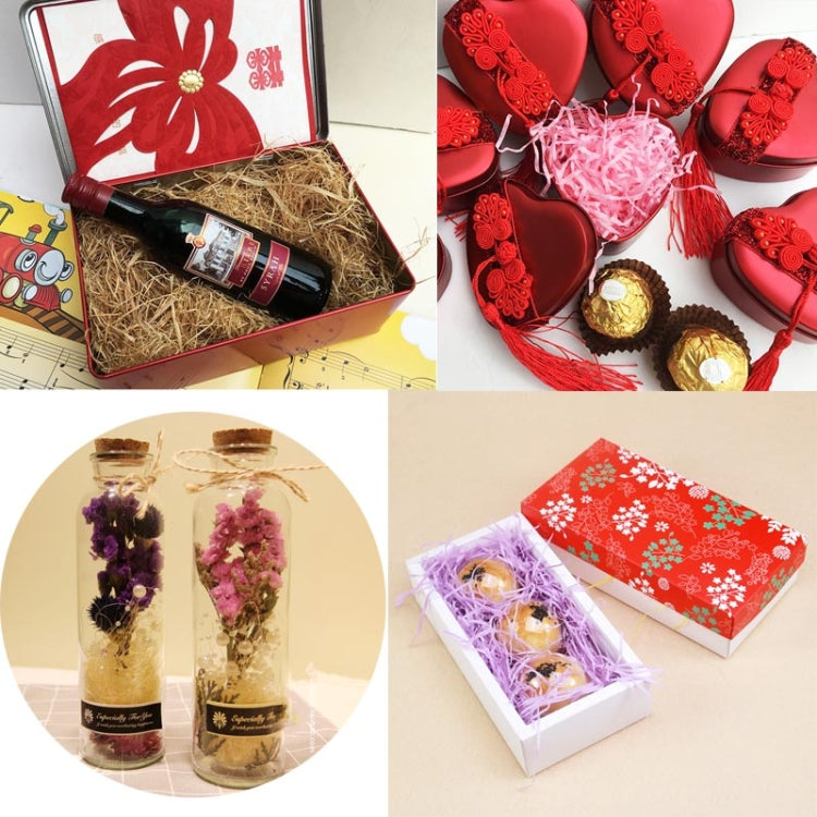 Gift box with shredded paper filler assortment, tan and pink strands inside