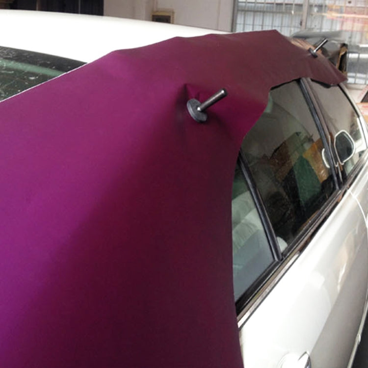 Black magnet holder post with disk base fastening vinyl on a car window