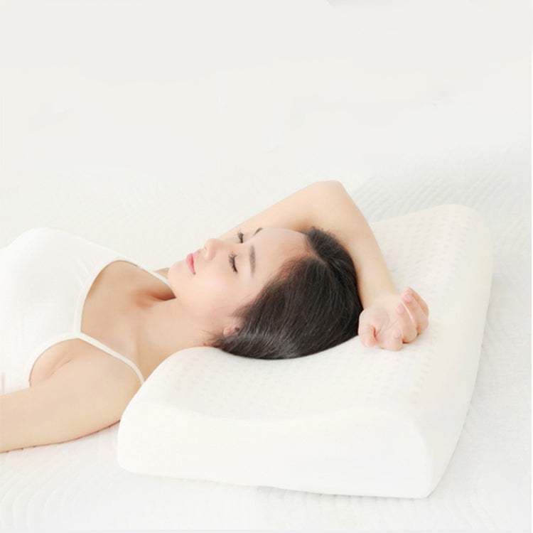 Contoured white latex pillow with cotton cover for neck and spine support