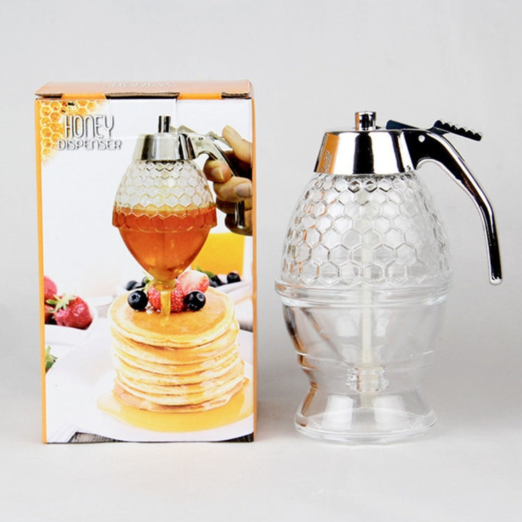 Transparent honey dispenser with chrome spout and hex-pattern container, boxed set shown