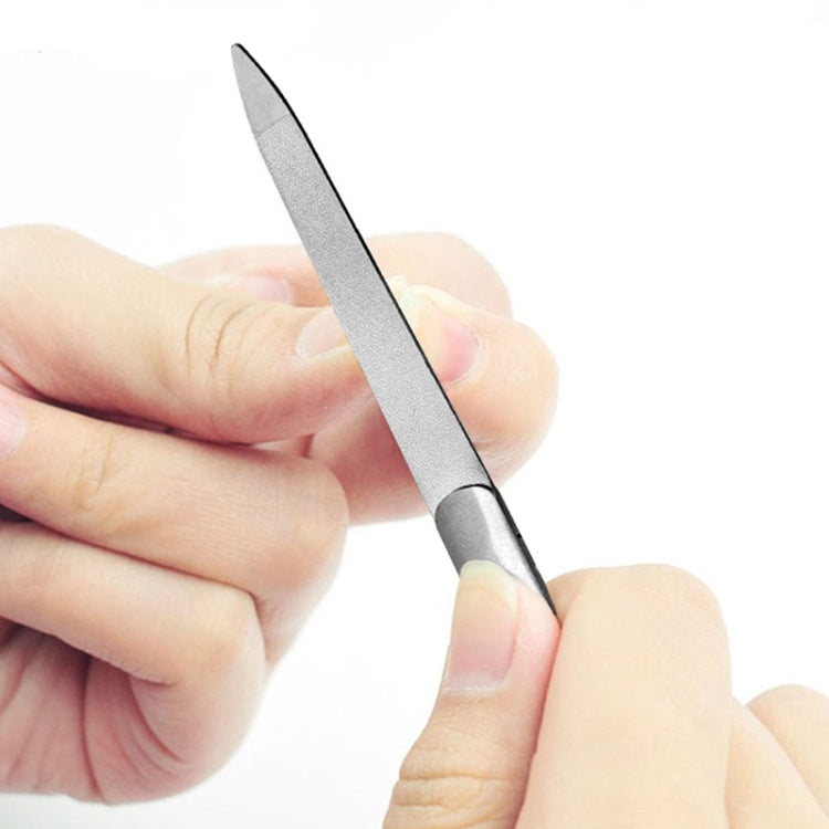 Hands using a polished stainless steel nail file with a pointed edge
