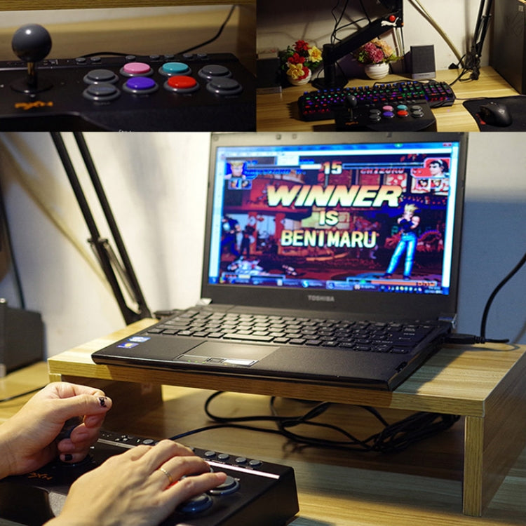 Handheld game controller with thumbstick and colorful buttons, used with gaming laptop.