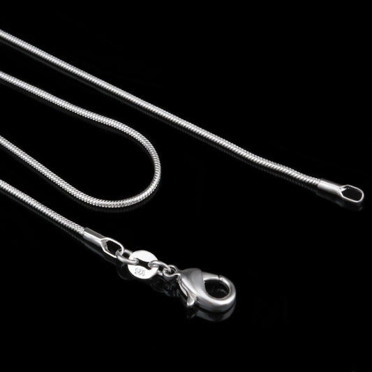 Close-up silver chain necklace with swivel lobster clasp and long snake-bone links