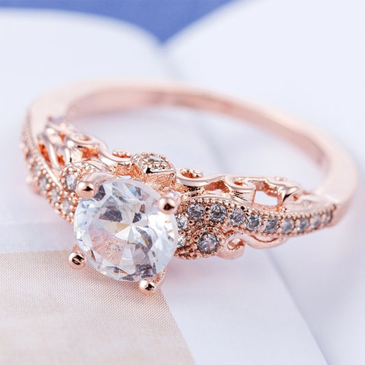 Rose gold zircon engagement ring with round center stone and filigree pavé band