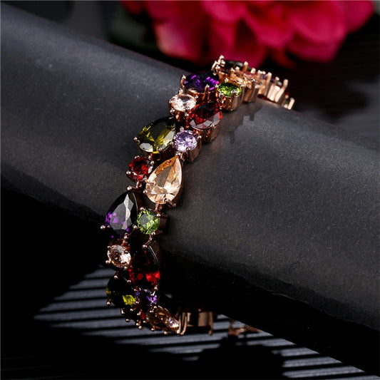 Rose gold bracelet with mixed purple, green, and amber zircon stones