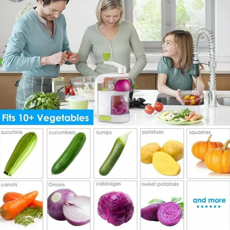 Manual vegetable slicer being used on a table with assorted fresh vegetables