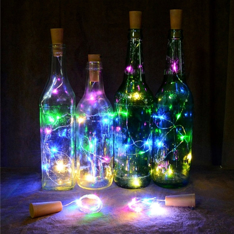 Colorful LED solar string lights illuminating bottle-shaped decor and copper wire