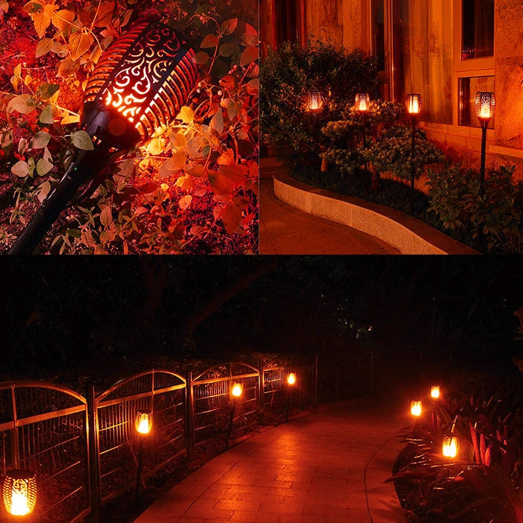 Multiple outdoor solar flame torch lights illuminating a garden path with warm glow