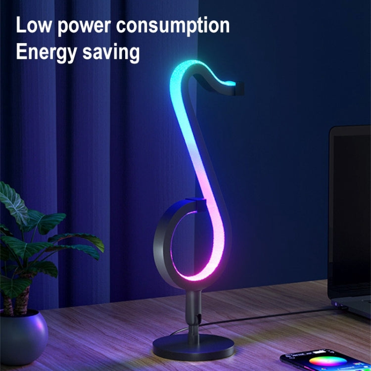 RGB musical note LED desk lamp with round base and remote on tabletop