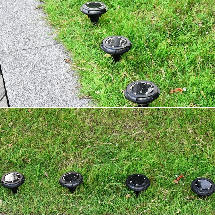 Multiple black solar ground LED lights placed on lawn and along a walkway
