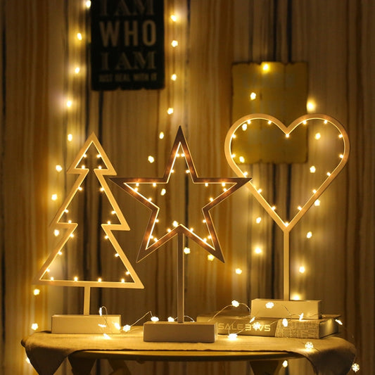 Decorative LED night lights: tree, star, and heart outlines on stands, warm glow