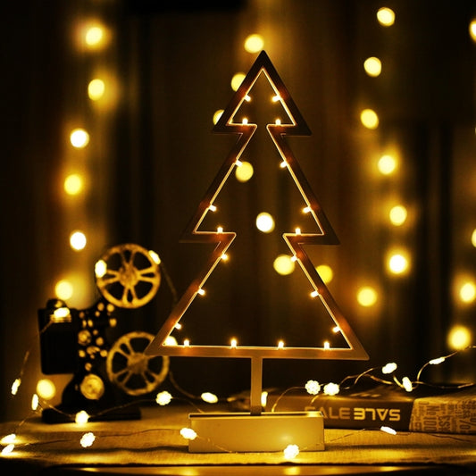 Decorative tree-shaped LED night light on a base, warm glowing outline