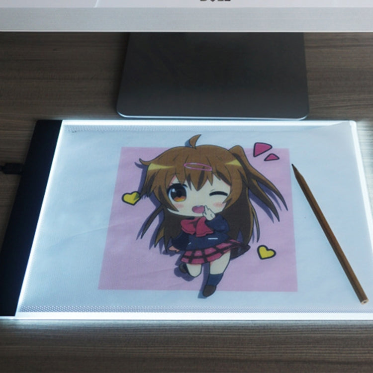 Portable USB LED tracing light box showing colored anime art, stylus and pencil on surface